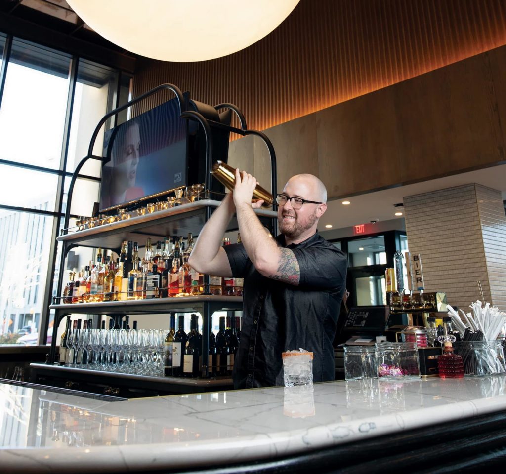 A bartender shaking a cocktail