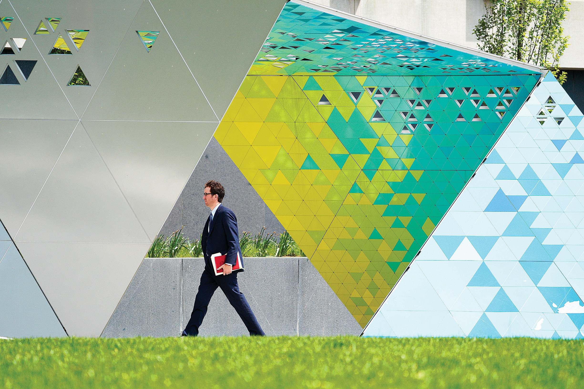 a man walking in the greener future of downtown