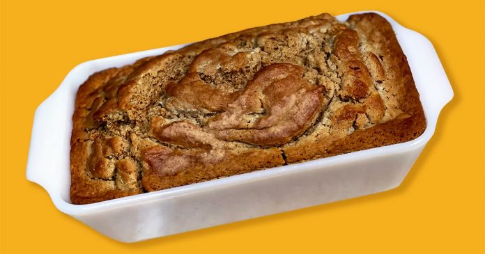 A loaf of brown bread on a yellow background