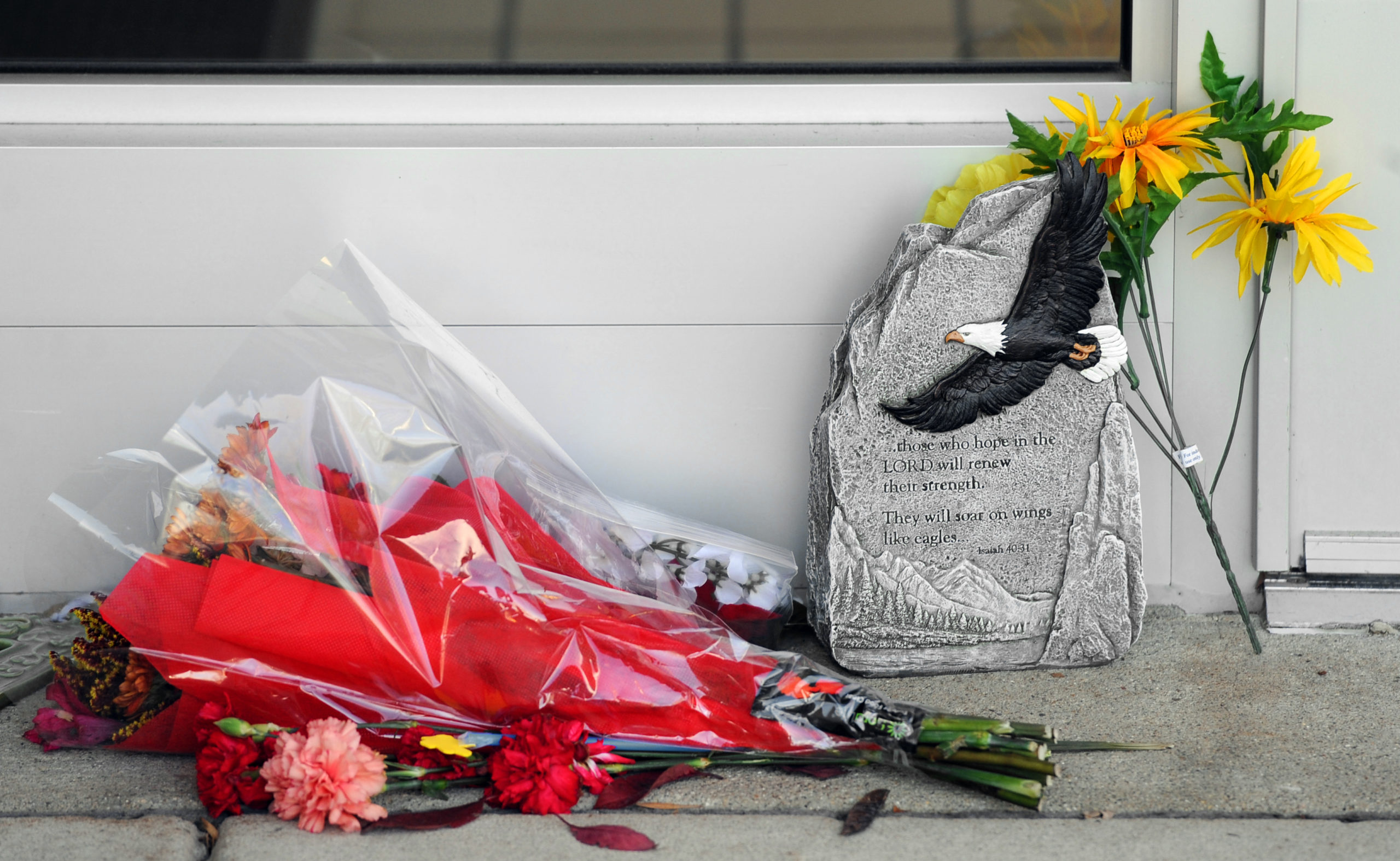 bouquets of flowers and a prayer plaque